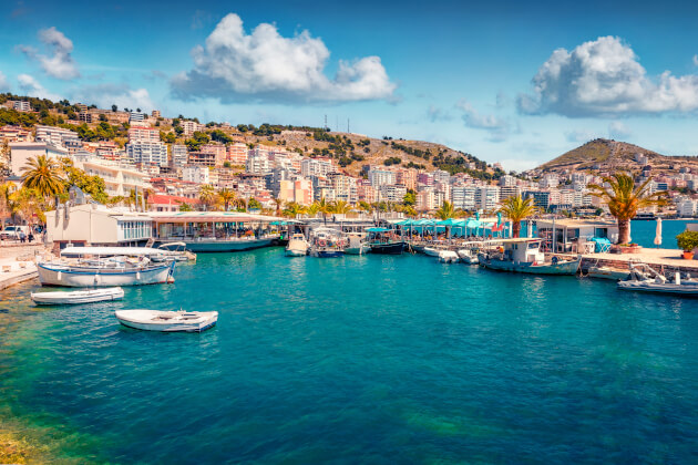  Hafenpromenade von Saranda mit Blick auf das türkisfarbene Meer und moderne Gebäude. | Gebeco