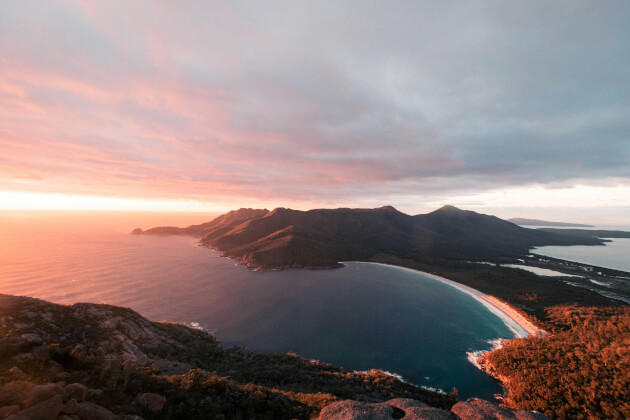 Atemberaubender Blick auf die Wineglass Bay in Tasmanien bei Sonnenuntergang mit türkisblauem Wasser und Bergen. | Gebeco
