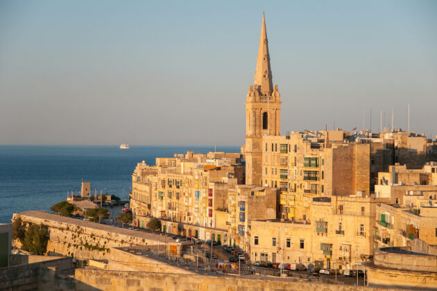 Historischer Kirchturm in der Altstadt von Valletta mit Blick auf das Mittelmeer bei Sonnenuntergang. | Gebeco