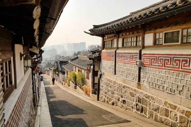 Traditionelles Hanok-Viertel in Bukchon, Seoul mit Blick auf moderne Skyline im Hintergrund. | Gebeco