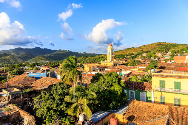 Blick über Trinidad auf Kuba mit Kolonialhäusern, Kirchturm und Bergen