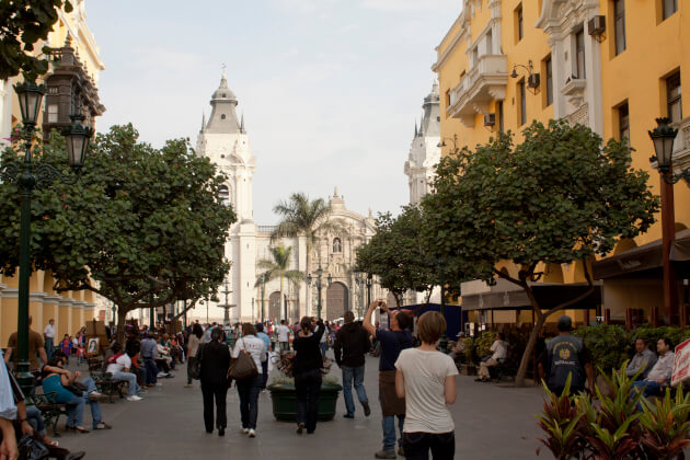 Plaza Mayor von Lima mit Kathedrale, Palmen, kolonialen Gebäuden und Menschen bei Tageslicht. | Gebeco